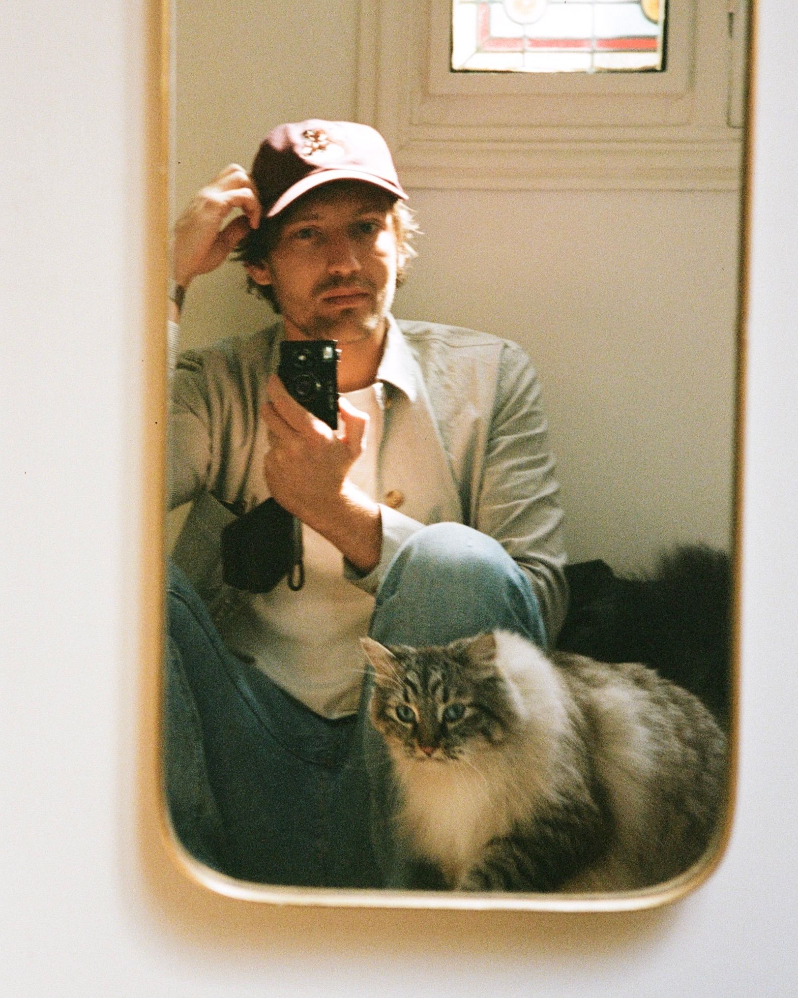 Mirror selfie with grey cat Quark taken with a Rollei 35S.